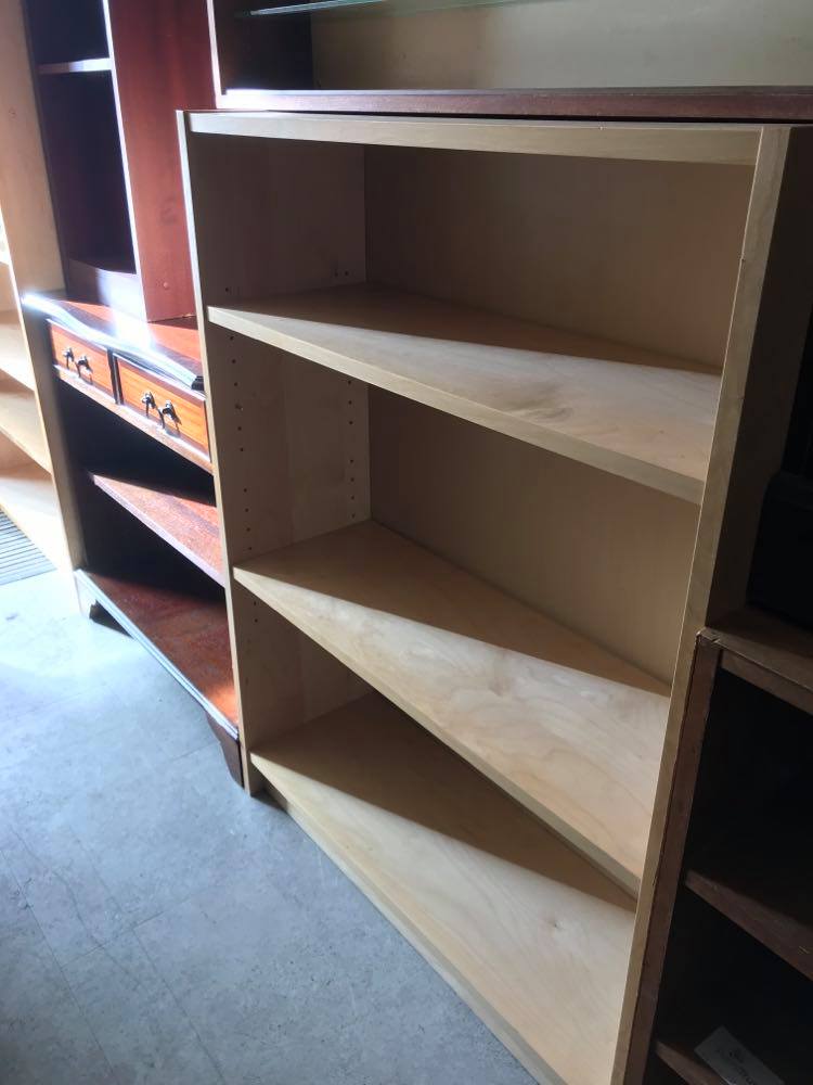 Low Ikea bookshelf in light wood finish